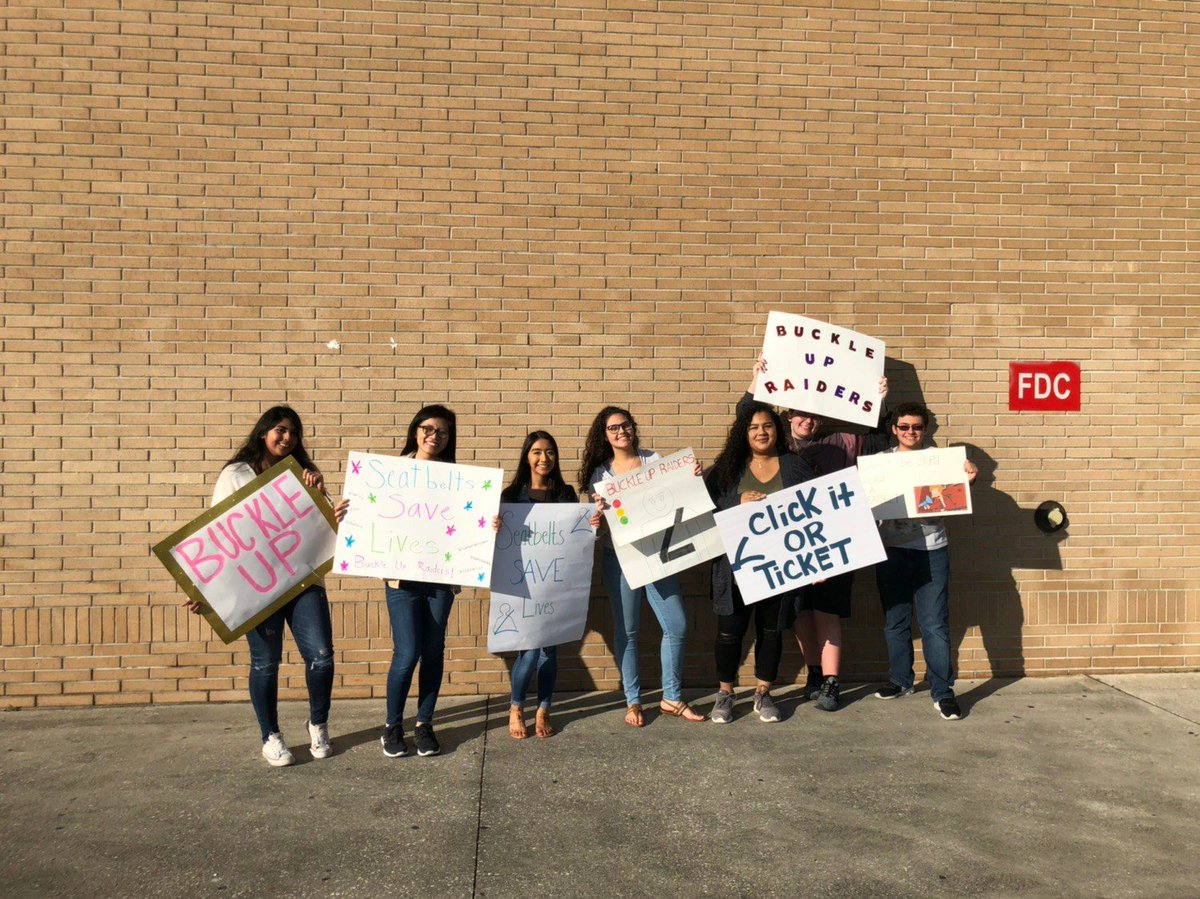 Day 5: Holding up posters afterschool to remind everyone to Buckle Up! #battleofthebelts #seatbeltsafety