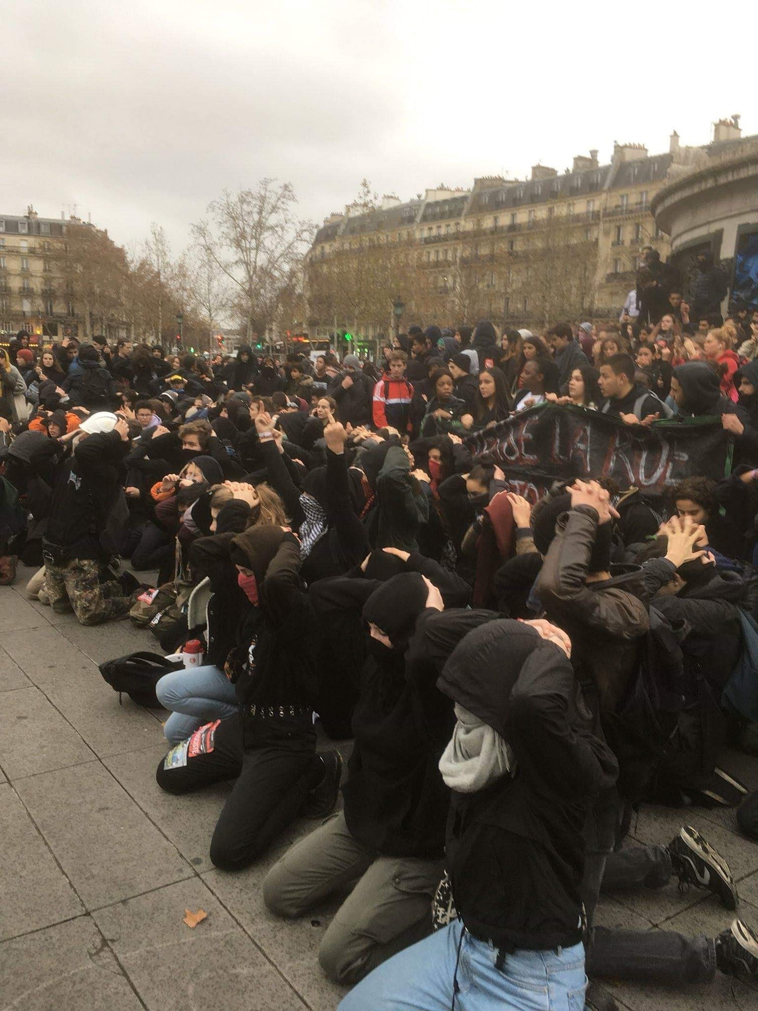 French high school students protesting in the streets of a city.