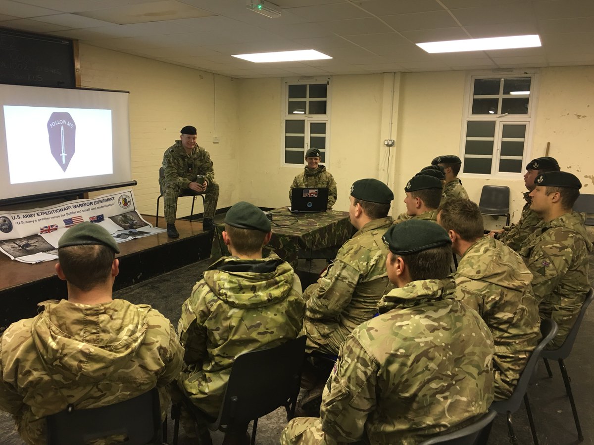 ArmyAEWE's tweet photo. UK 1st Platoon, Salamanca Company, 3rd Battalion the Rifles being briefed by the XO of the US Army Maneuver Battle Lab. Covering Ft Benning life and AEWE19 Force on Force phase in 2019, whilst they are at AWE18 - Autonomous Warrior (Land) on Salisbury Plain. https://t.co/Pxd1Ua1rzC