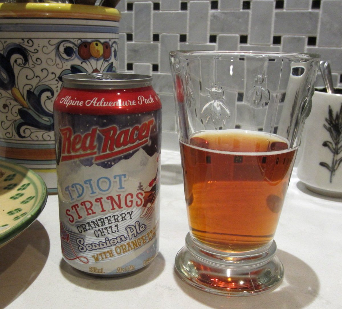 pentictonpost's tweet photo. Advent beer! Who knew? And commemorated on the label of a so-delicious @redracerbrew beer: the long strings attached to those "idiot mitts" your aunties knitted you when you were a kid. "Idiot Strings Cranberry Chili Ale" 🍻#StrongAle #BeerReport #knitting https://t.co/5PzsNB6bI3