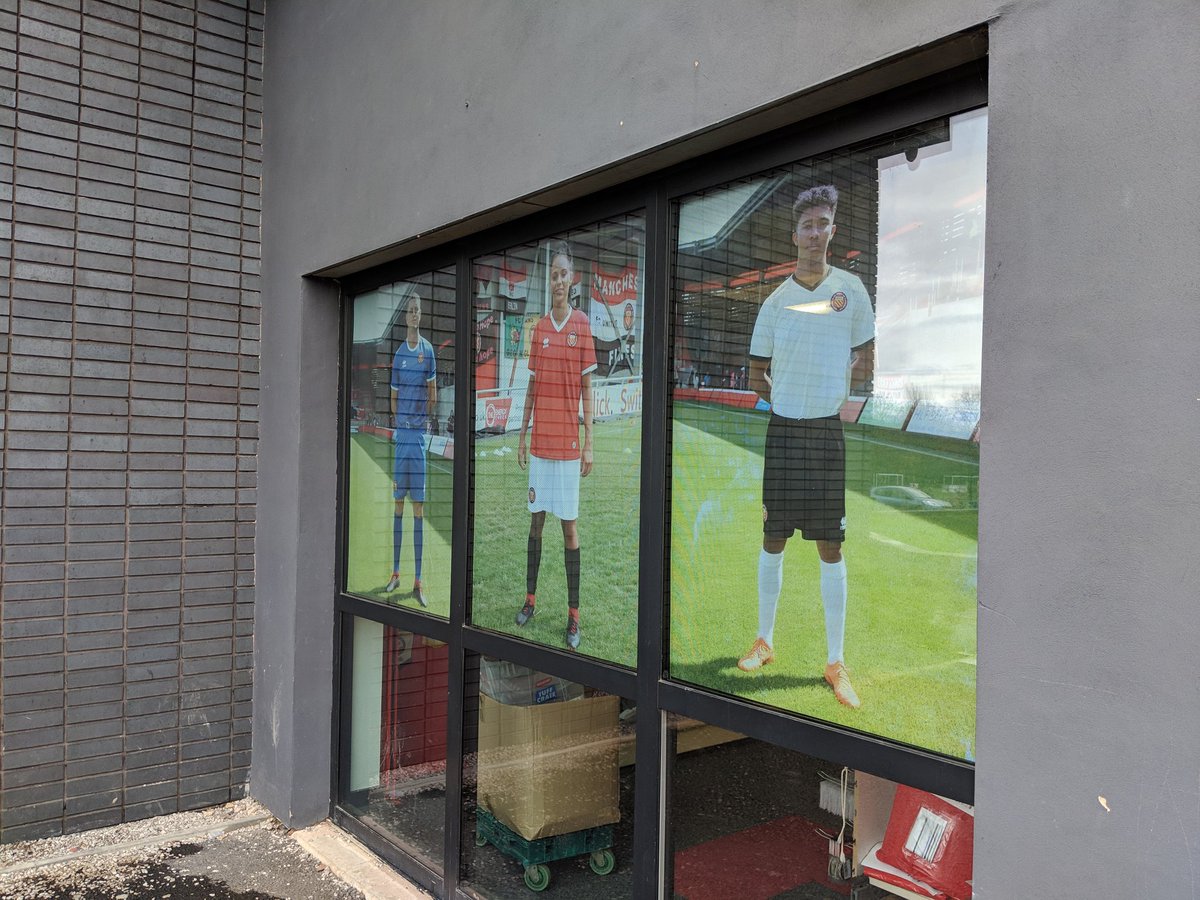 FCUnitedMcr's tweet photo. The front of the club shop is looking a bit more colourful today. Now open for all your pre and post match Christmas shopping needs. https://t.co/4BqGGS6e4U