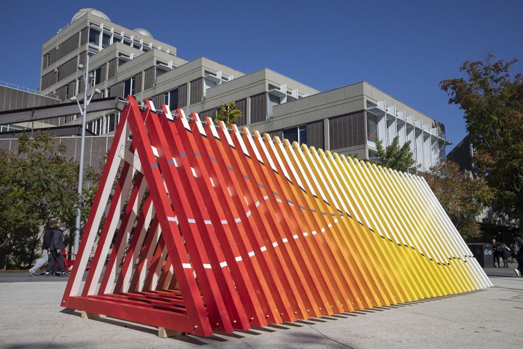 A large art installation featuring red, orange, and yellow triangles 
