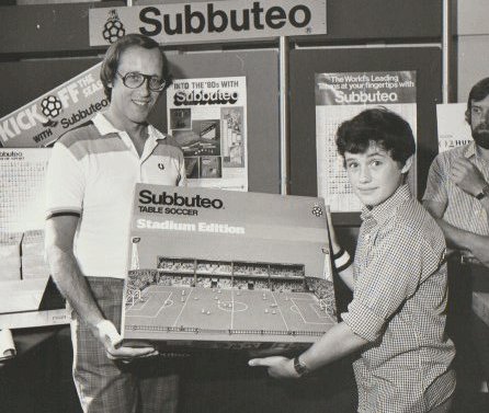 BarrieEditor1's tweet image. Just found this photo. It's me, presenting a Subbuteo prize to a competition winner, at either a Tiger or Roy of the Rovers event.  I guess the winner is middle-aged by now.  Anyone you recognise? Or is it you?