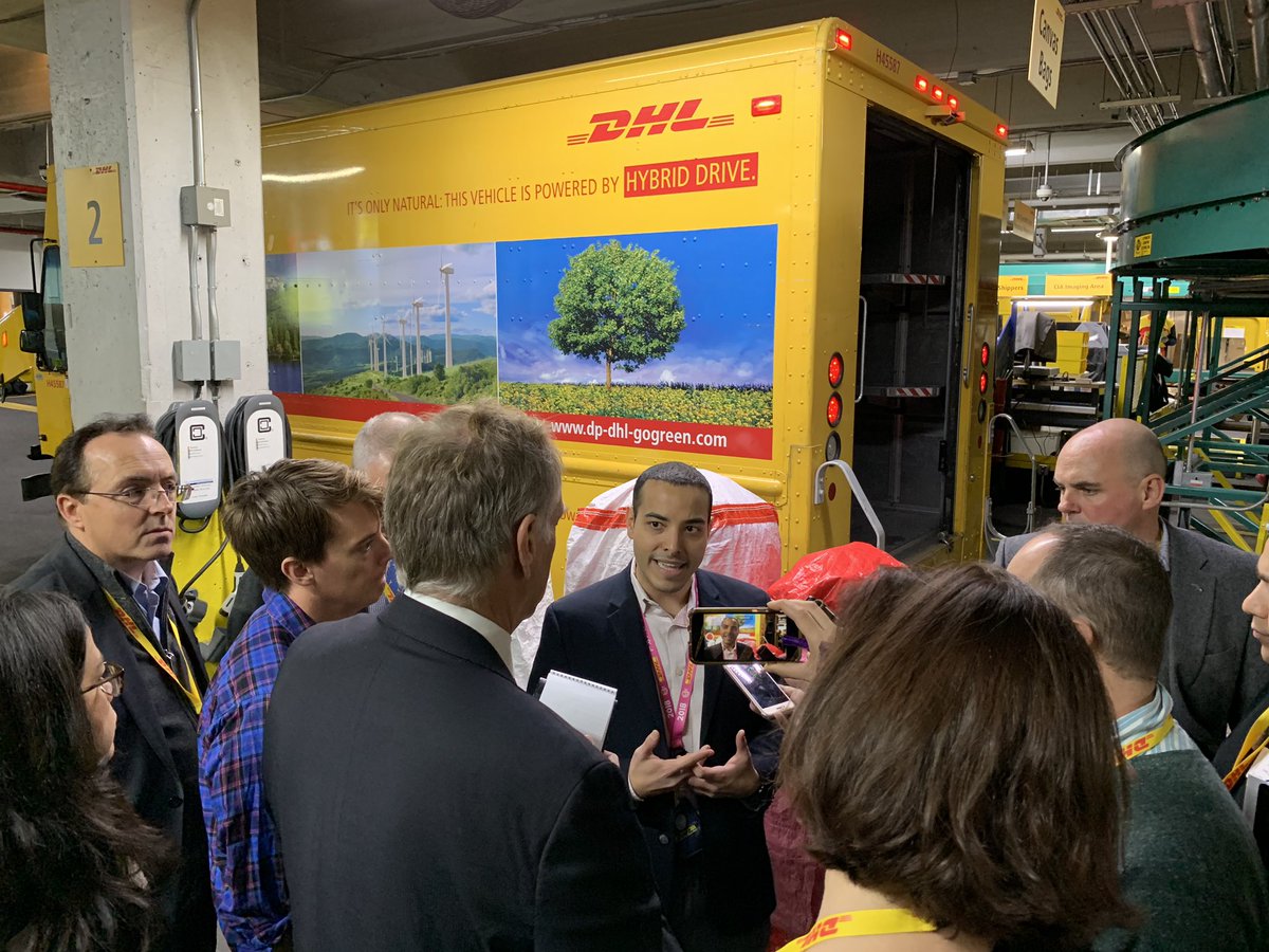 DHLAmericas's tweet photo. Our #DHLExpress NY Area Operations Manager shows journalists our #Green fleet. We have 47 #hybrid and 41 fully #electric vehicles in Manhattan. Our mission is #zeroemissions2050. Happy #DHLeHolidays! https://t.co/gpzMDRHPcv