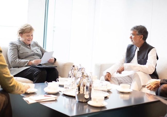k_satyarthi's tweet photo. Met German Chancellor Angela Merkel today. Grateful for her positive response to my demand for a legally binding @UN Convention against online child sexual abuse. Also, discussed safety of refugee children &amp; commitment of German companies to ensure #childlabourfree supply chains. https://t.co/BdCcV9hzQC
