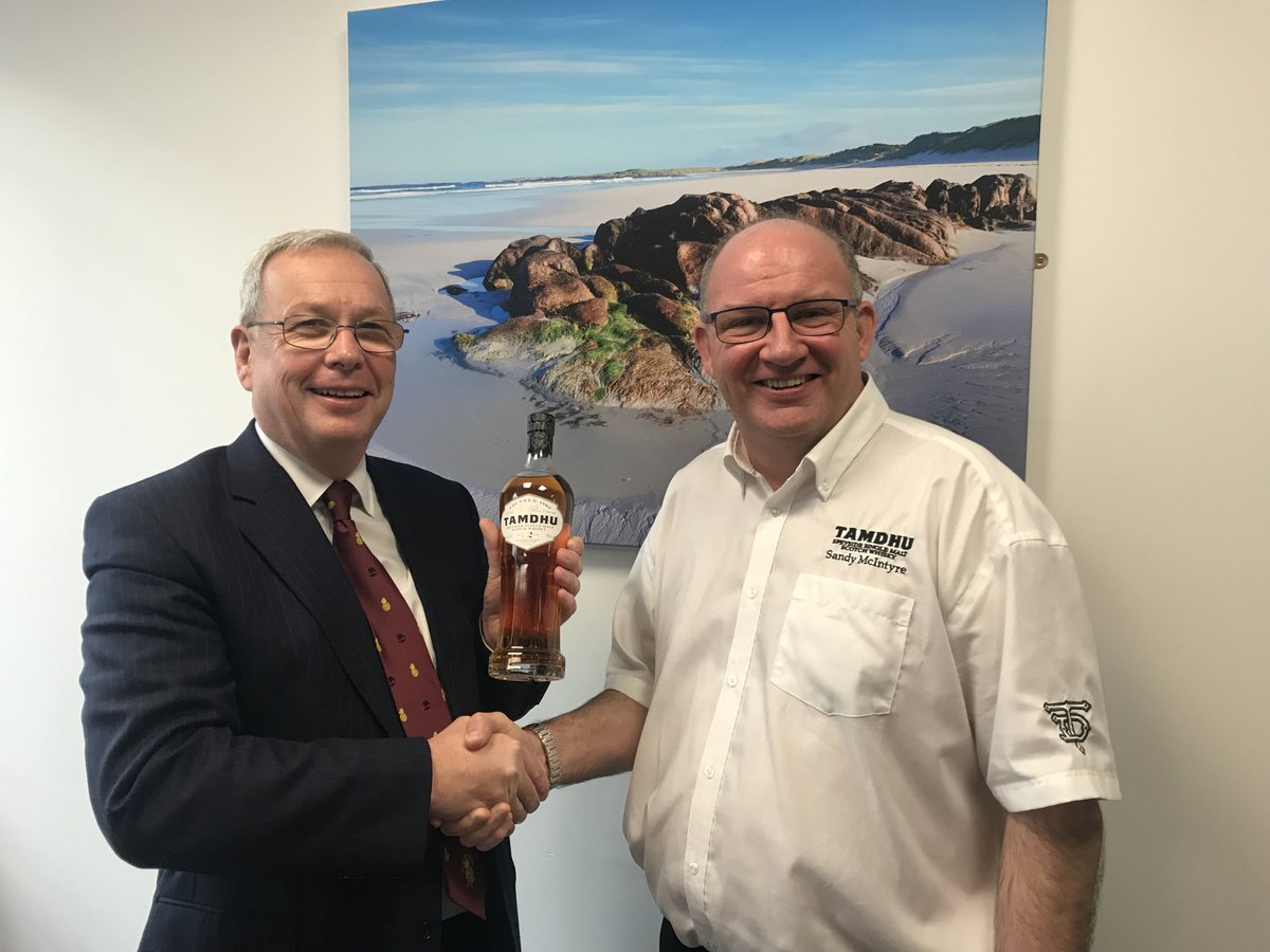Deacon Alasdair receiving a special Tamdhu single malt whisky from Sandy McIntyre, Distillery Manager at Tamdhu, for auction and support of the Coopers charitable works.