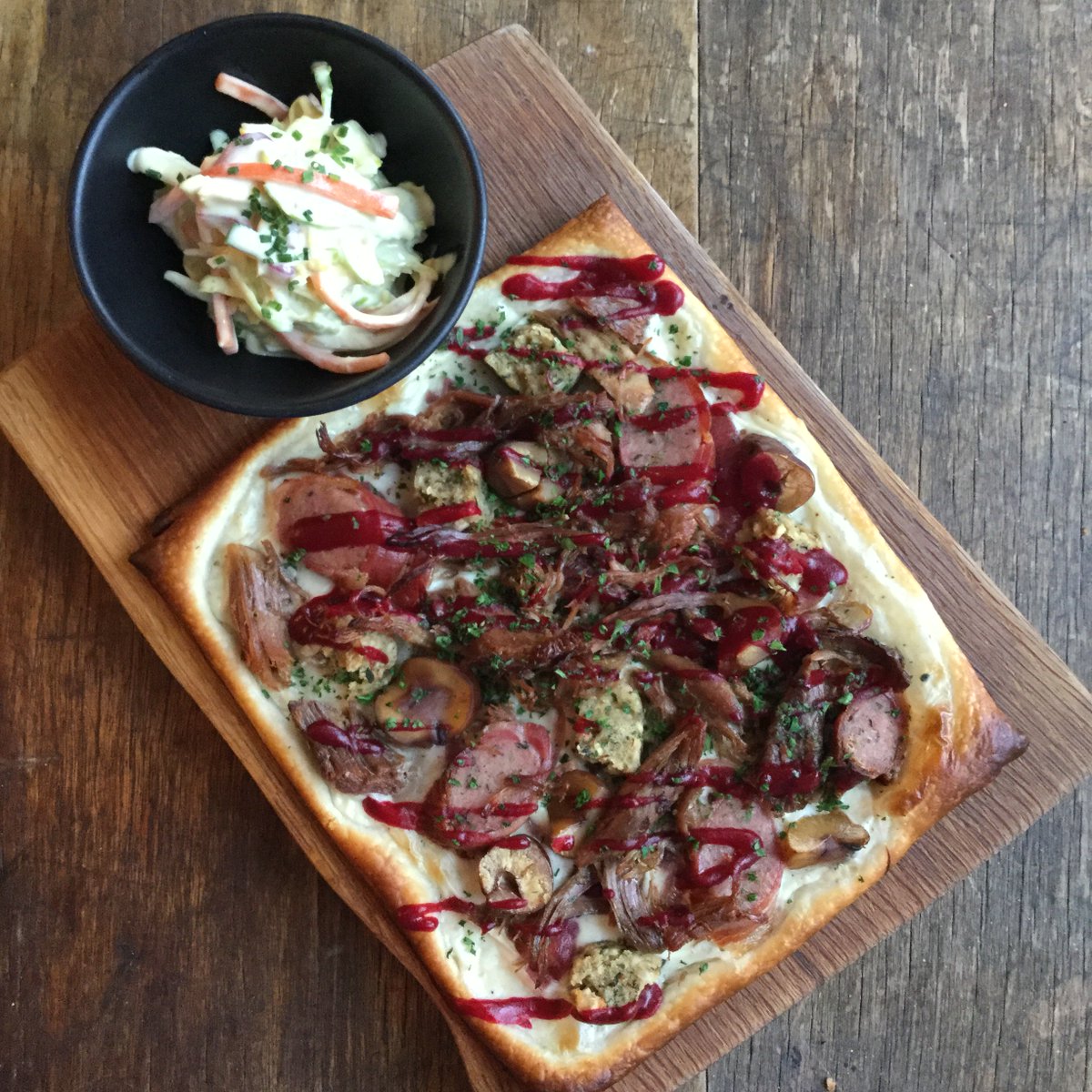 TandCakeCafe's tweet photo. Tiring of Christmas sandwiches, we’ve decided to do a festive version of our Tarte Flambée this year. Béchamel, confit turkey leg, stuffing, pigs in blankets, onion marmalade, chestnuts and cranberry, with a Brussels slaw side. 🇪🇺 https://t.co/lqK4xa7wi0