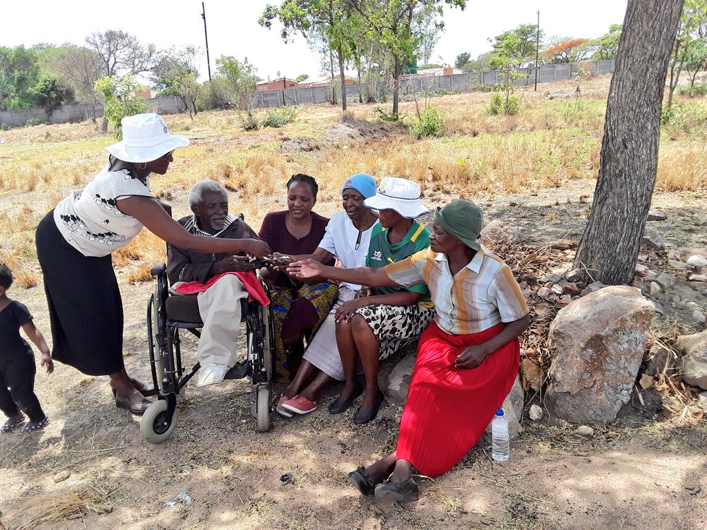 Bulawayo ward 17 councillor Sikhululekile Moyo with community leaders handing over money to  disadvantaged families in her ward on Tuesday. Two families benefitted from cash sourced from #ZDDT