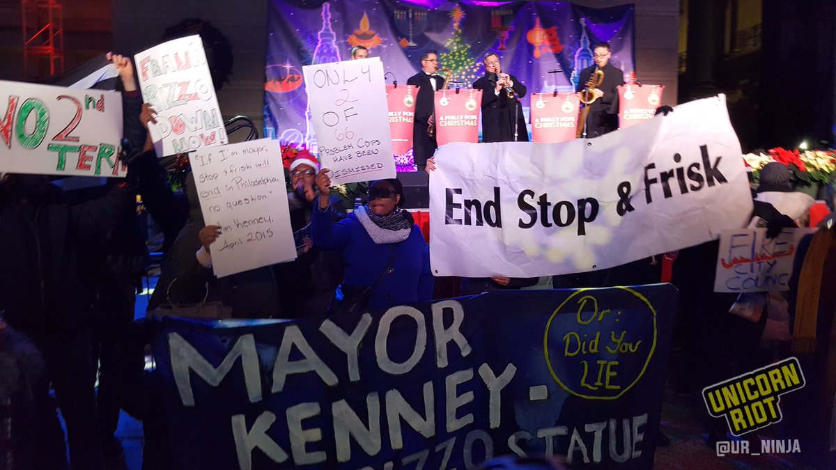 UR_Ninja's tweet photo. Protest against #StopandFrisk has essentially taken over the #PhillyHolidayFest by standing in front of the stage with banners. No arrests made, event musical program is still proceeding as scheduled https://t.co/uq1Y85gmsn