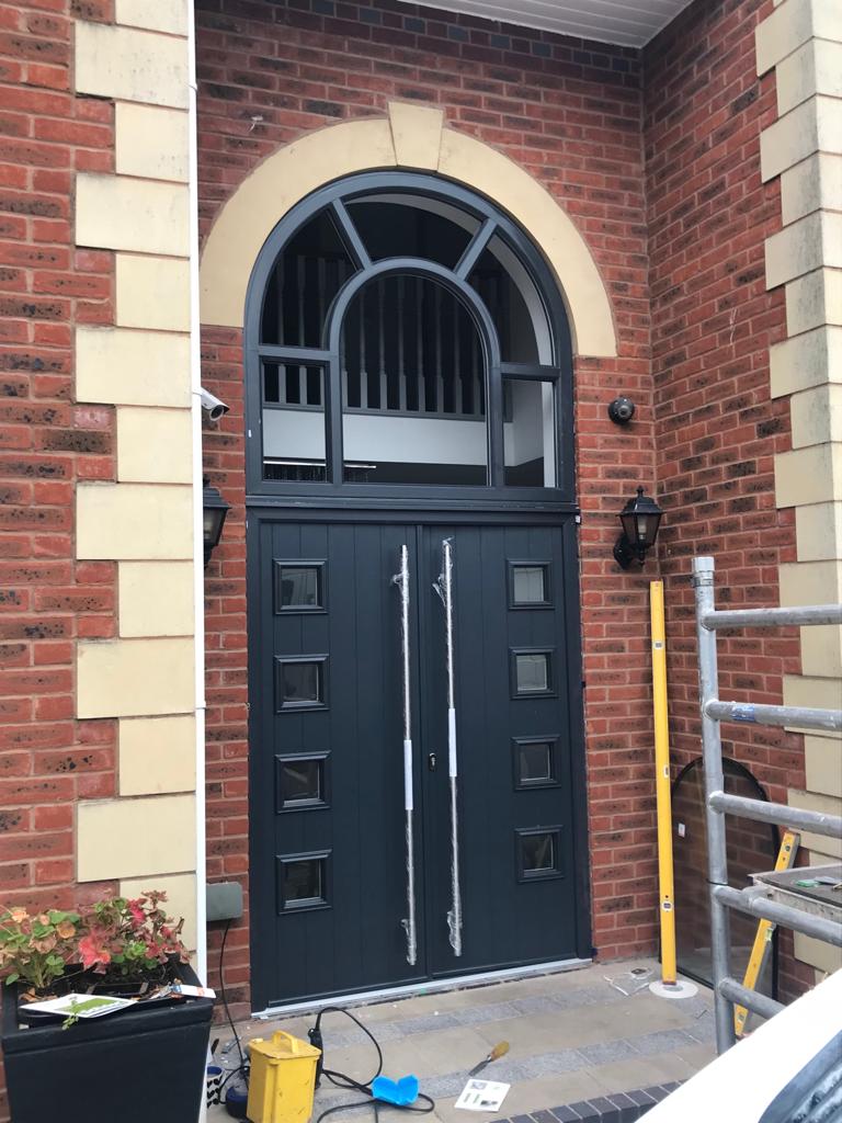 Windoworld's tweet photo. Brand New fitting! RAL7016 Anthracite Grey double Composite Doors with a huge arched window fitted by one of our fantastic teams, pictured here in action! Give us a call on 01257 367 899 for Chorley &amp; surrounding or 0151 531 0056 for Liverpool &amp; surrounding for your free quote! https://t.co/RAqZTZfoIb