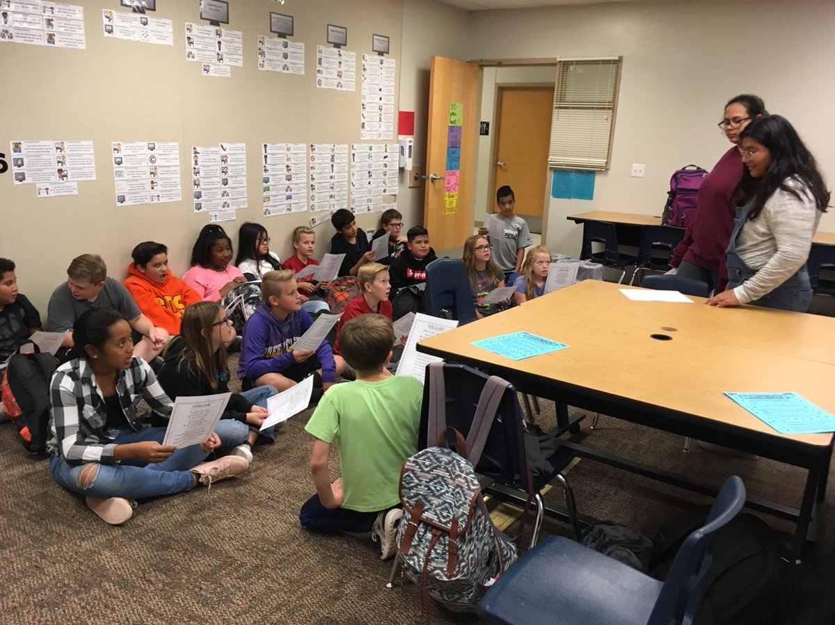 Students from J.O. Combs High School teaching 6th graders holiday songs in French!