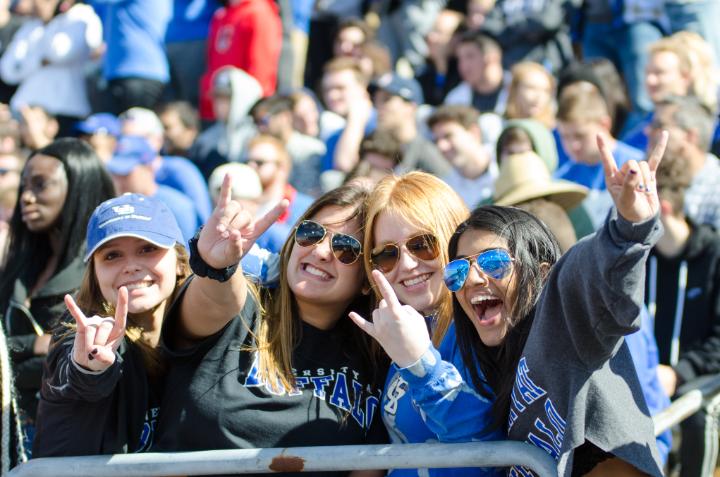 Students with their UB Horns Up cheering on the Bulls at a game
