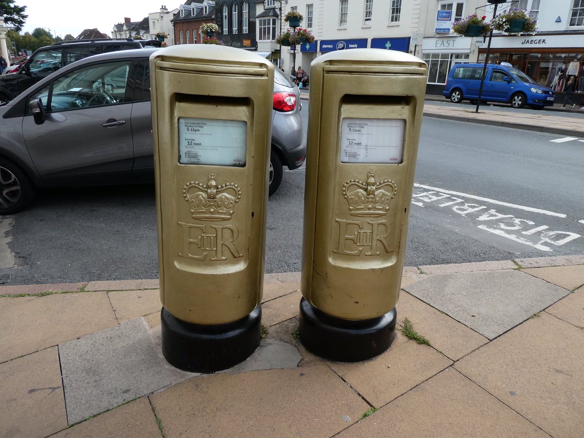 KateVause1's tweet photo. @clockwork_dolly @RoyalMail I love that! First time I’ve heard of this. I have, however, spotted some gold pillar boxes which were painted for local Olympic gold medal winners. These are in Stratford upon Avon. #RoyalMail #postboxes #pillarboxes https://t.co/cf7SpvJodX