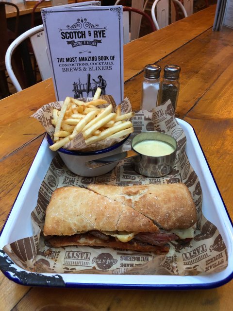 HAPPY #STANDREWSDAY 

Celebrate by tucking into our special this weekend. It’s the best of America &amp; Scotland and it’s super tasty! Steak sandwich that’s topped with haggis, Emmental cheese, red peppers and it’s served with chips and Scottish whisky sauce – yum yum yum!