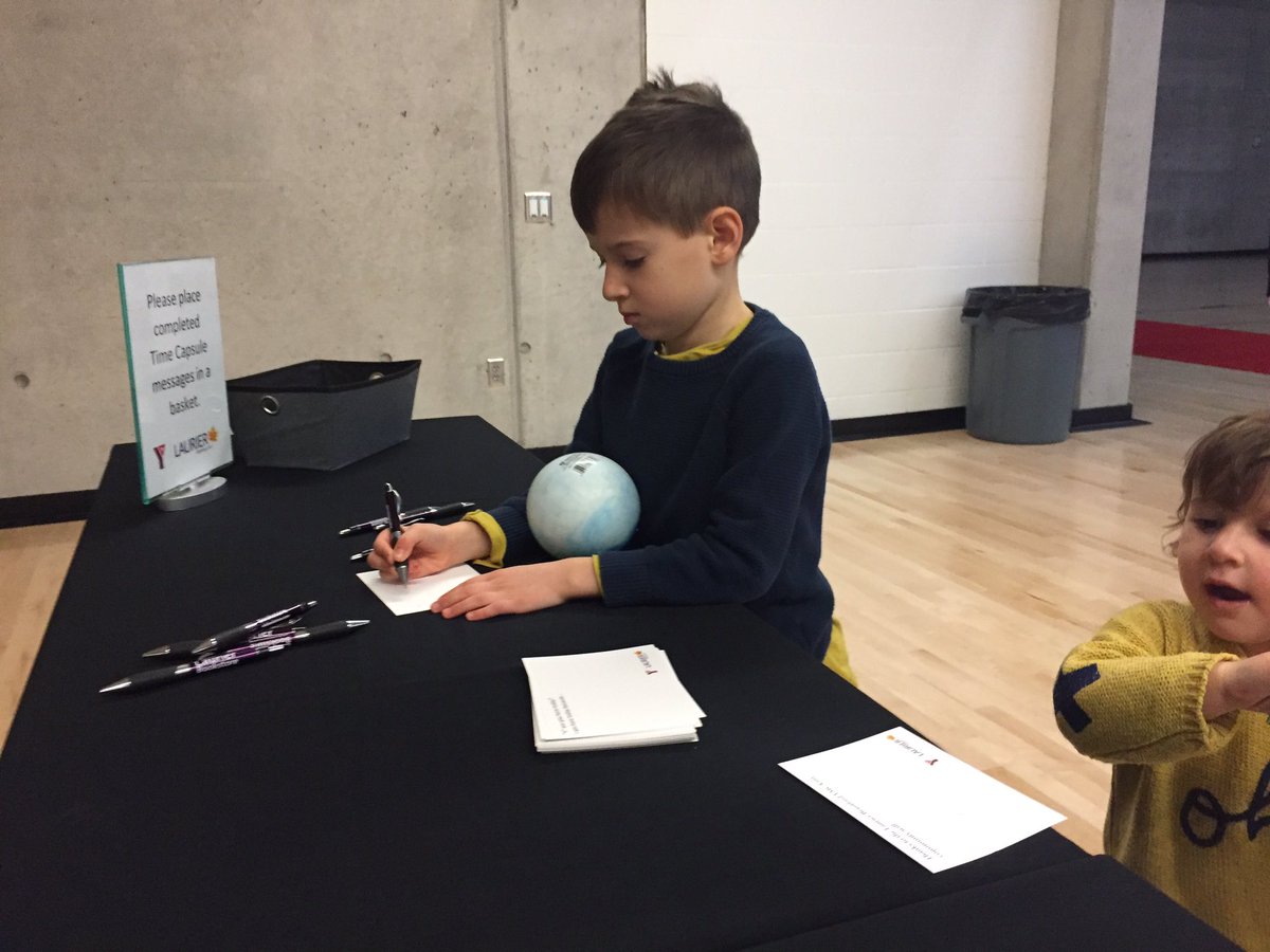 Luca is writing his thoughts about being here today and his hopes for his community will drop it in the time capsule, to be opened 25 years from now. #LaurierBrantfordYMCA #GrandOpening #KnowYourY @Laurier