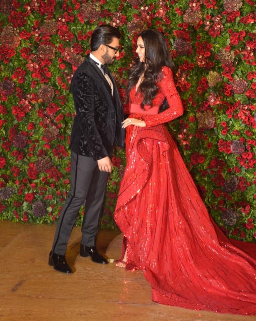filmfare's tweet photo. Caught in the moment! 
@deepikapadukone and @RanveerOfficial share a laugh as they pose for the shutterbugs at their reception. https://t.co/veab86NxS4