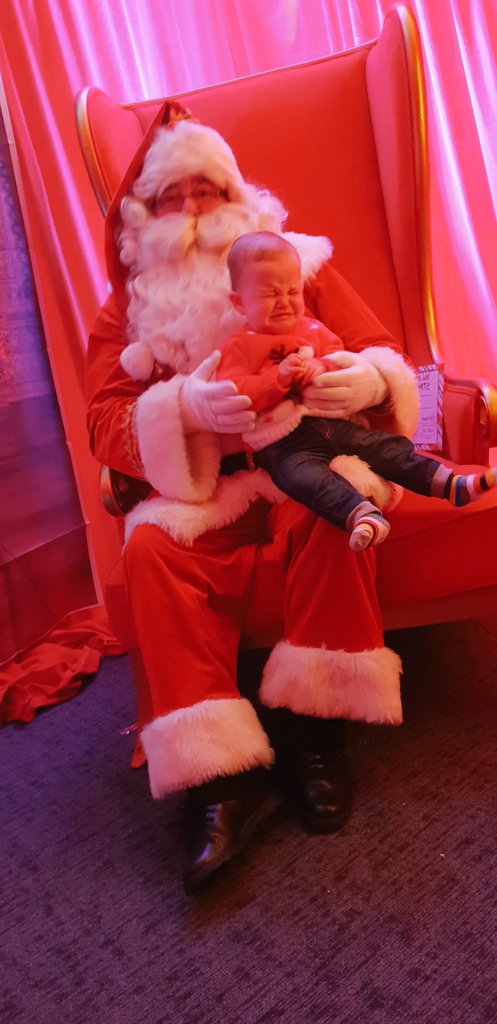 EGilp's tweet photo. This will forever be my favourite photo! Not impressed #firstsantavisit https://t.co/nmcIcen48E