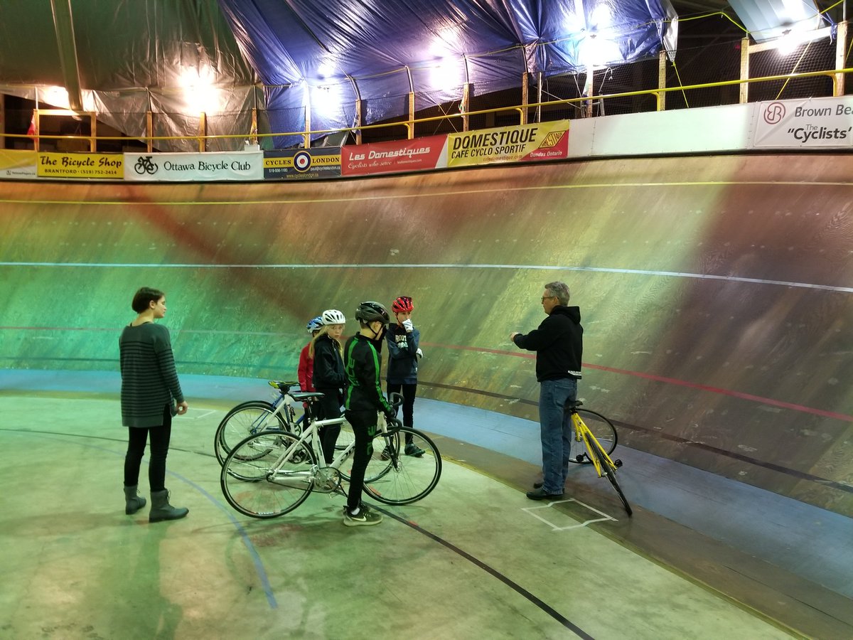 #FVC Velo kids. Coach ART with assist coach Catherine. Talking about cornering at FCV. 50 degree corner.