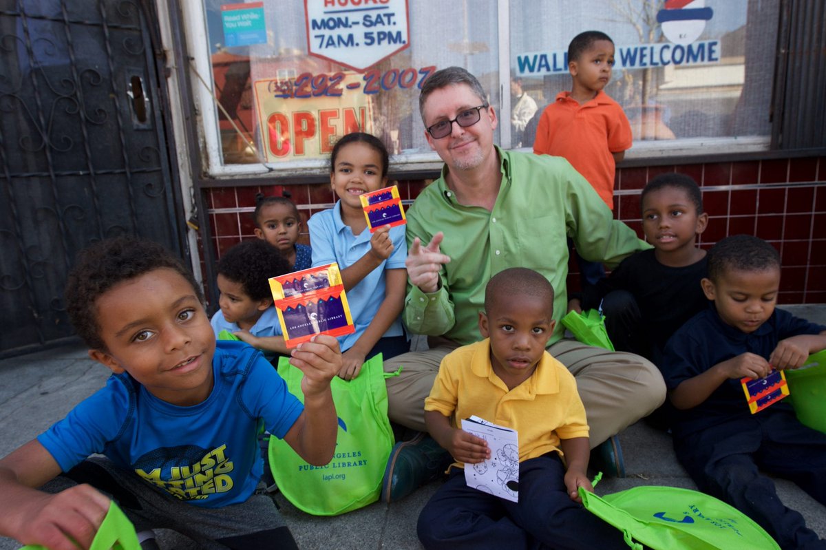 John with kids in front of barber shops