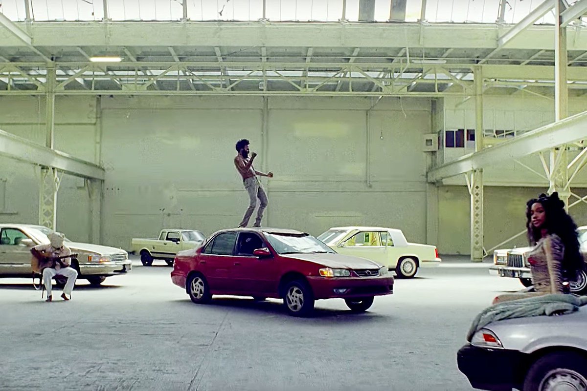auworldhistory1's tweet photo. The old cars shown in "This is America" is meant to show the lack of progression and forward movement America has taken since beginning of the slavery movement. It is meant to show how our society still treats blacks lives as lesser than those that are white. #tastp https://t.co/cI9GBqPWry