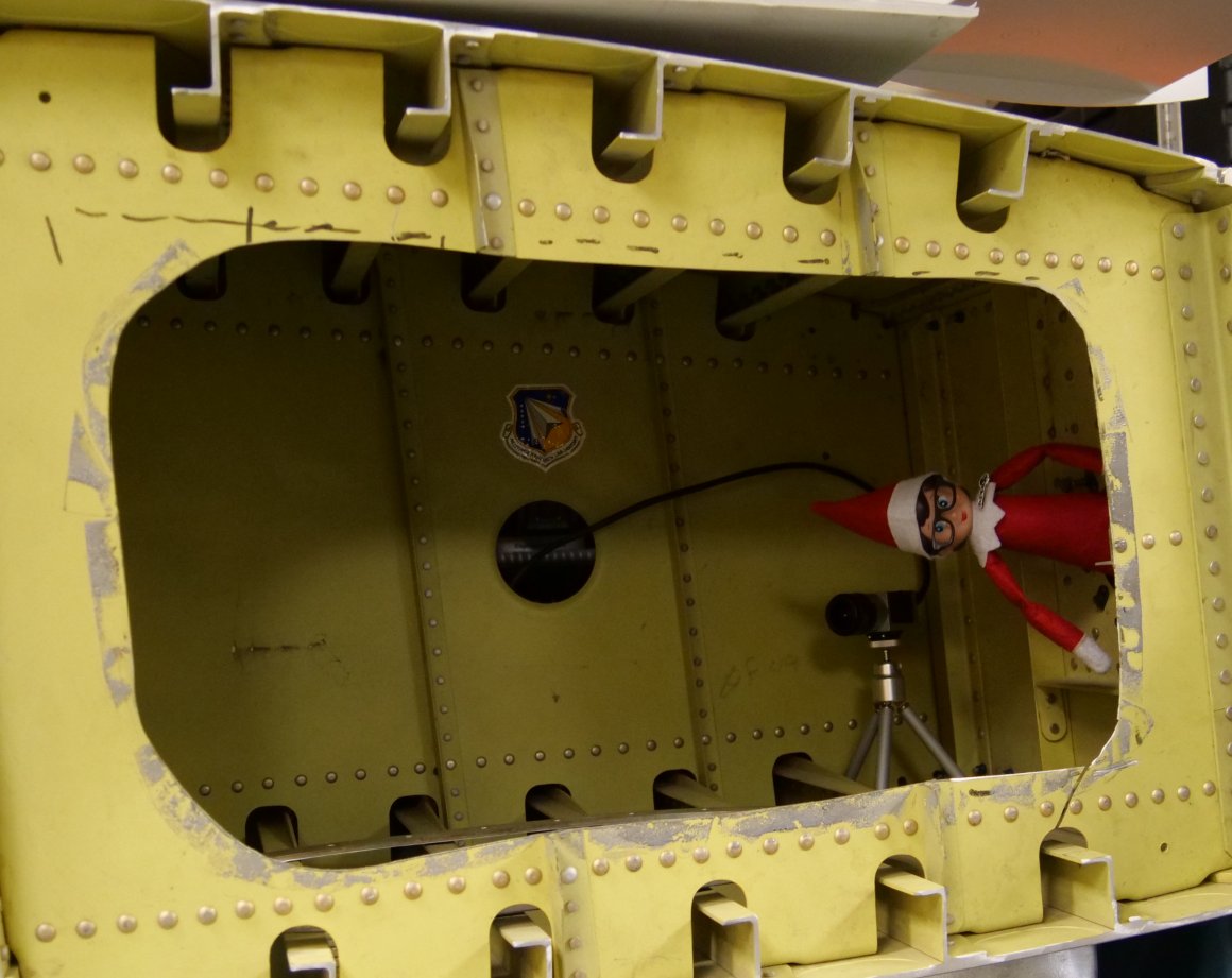 AFResearchLab's tweet photo. I'm just hanging out in a win-section AFRL used to test out devices that help monitor damage and weathering in aircraft! That's pretty fly! #ElfontheShelf #RosatheElf #ElfinSTEM https://t.co/H2nJwlRolz
