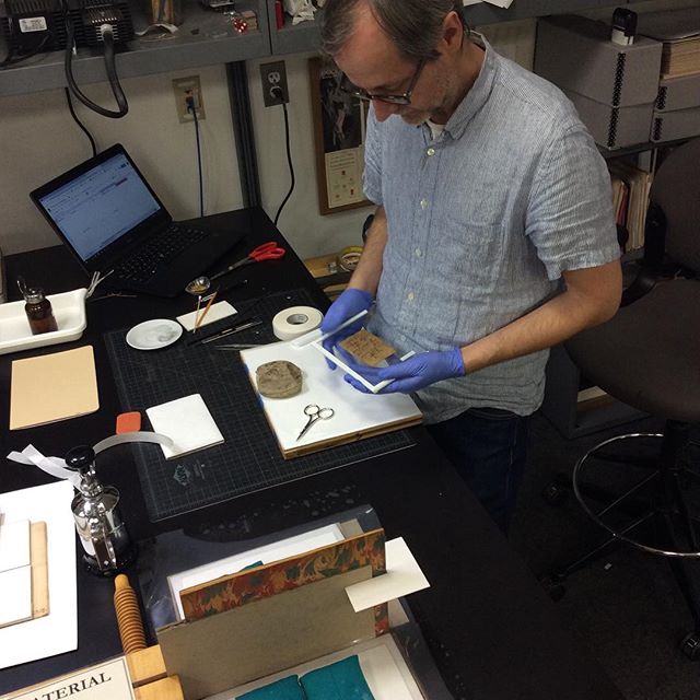 NYUPreservation's tweet photo. #humidifying boards, #sealing a #papyrus fragment in glass, #multitasking #likeaboss #todayinthelab https://t.co/gy5ThWyG3c