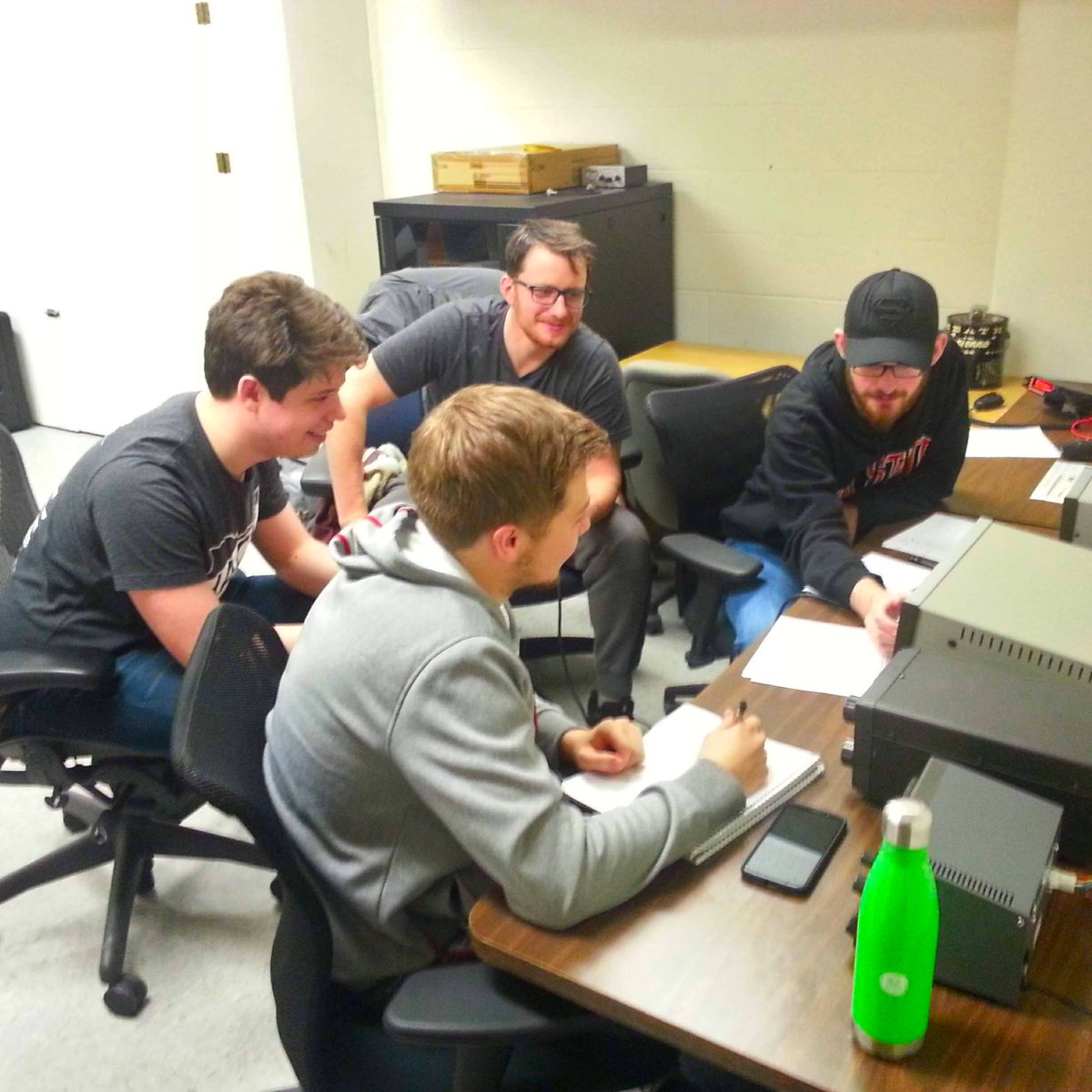 Ham radio operators making contacts on an HF transceiver.