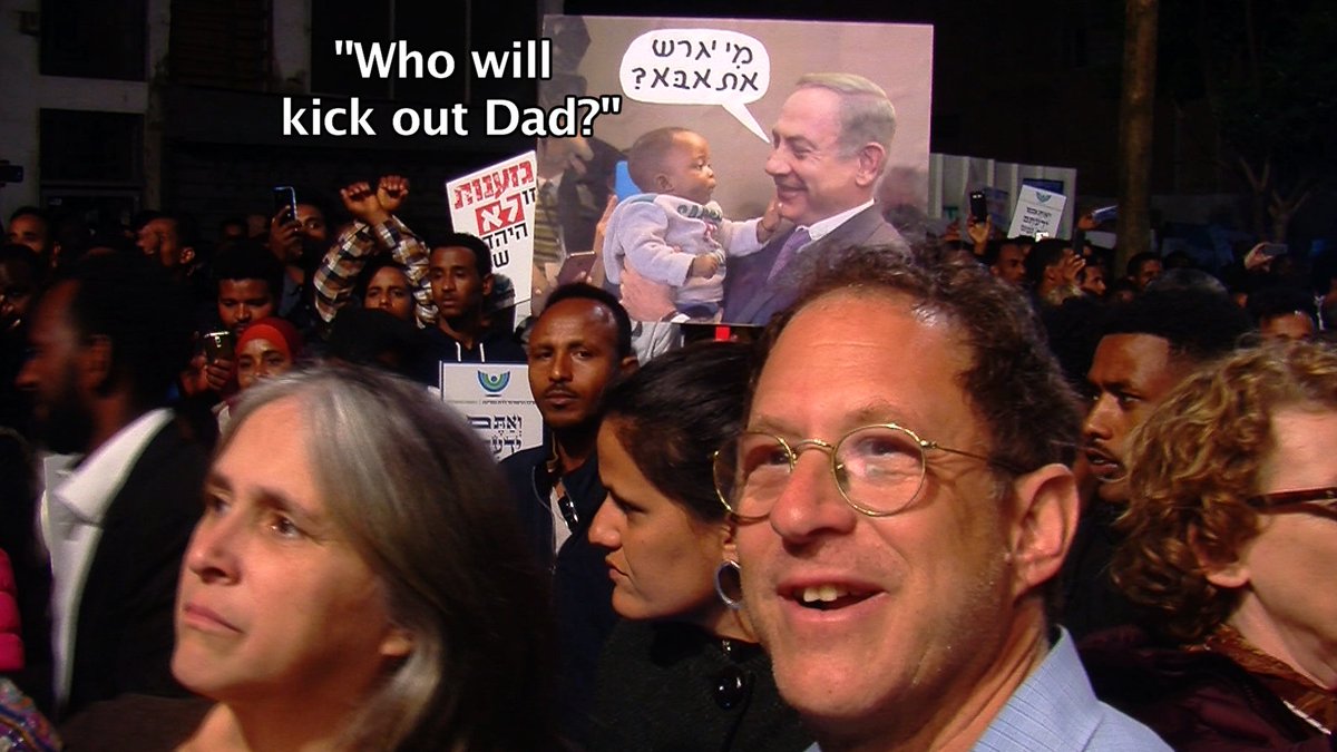 jerusalemnyc's tweet photo. The family that fights for human rights together, stays together. Yossi &amp; Susan at demo (Feb.2018) for African refugees in Israel. Check out poster of Bibi ;) 
This struggle will also be in "Green Rebel" - to add your energy to our pot, contribute here: https://t.co/ZR9Gm7p0mG https://t.co/F90NWC4U4e