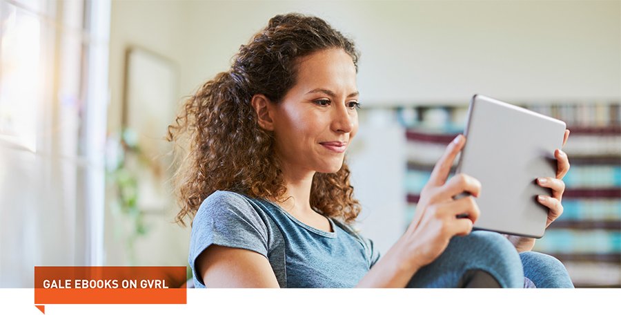 a woman smiling looking at her tablet