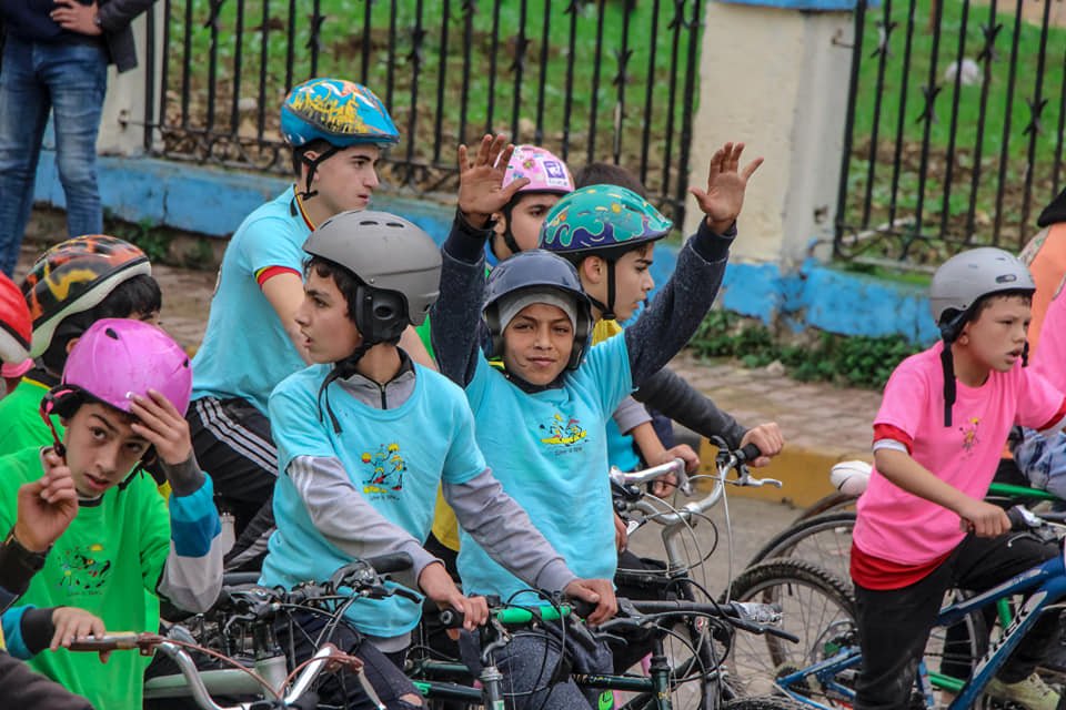 SyriaCivilDef's tweet photo. A bicycle race for the children of #Jisr_Alshughour City #Idlib, was organized by the #WhiteHelmets in cooperation with New Day #Syria, for #InternationalVolunteerDay. The winners were honored and prizes and gifts were distributed to them. https://t.co/yzQ3JntwxK