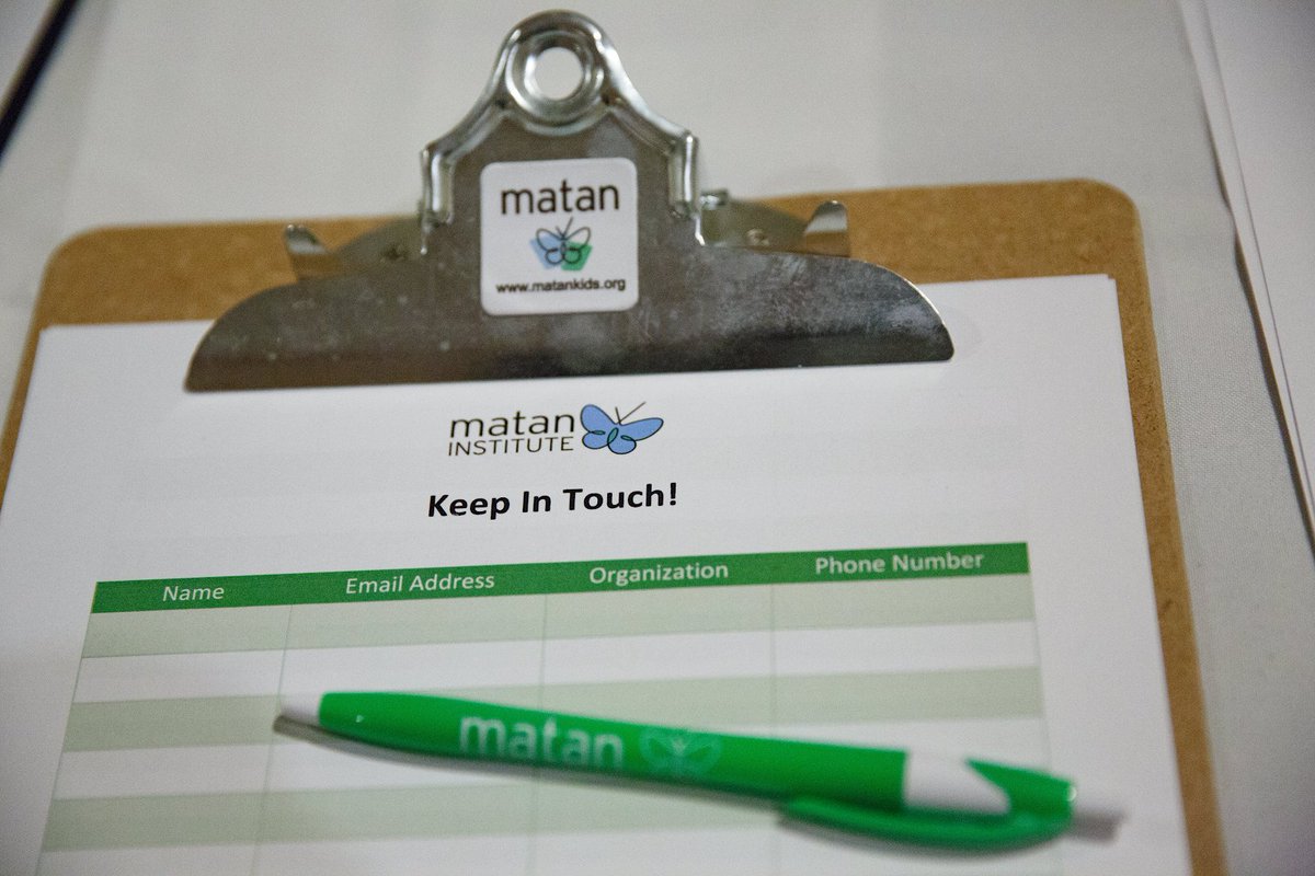 A clipboard with a signup sheet and pen.