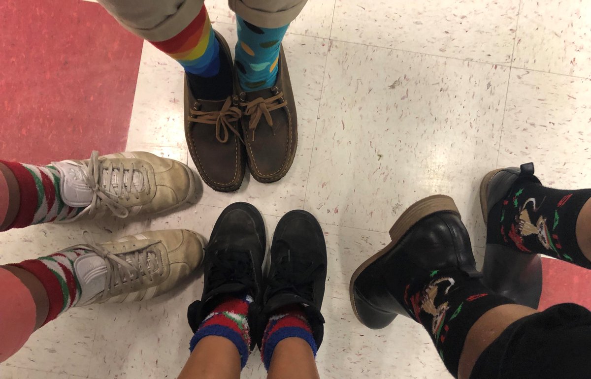 pi_siminger's tweet photo. There are 4 pairs of socks on the #SMSTeamUNC feet. How many individual feet have their mistle'toes' covered? @SMS_TeamUNC @StonewallMiddle #SMSReindeerGames2018 #realworldmath #theanswerisEIGHT #duh https://t.co/ZJ7R7iZhwa