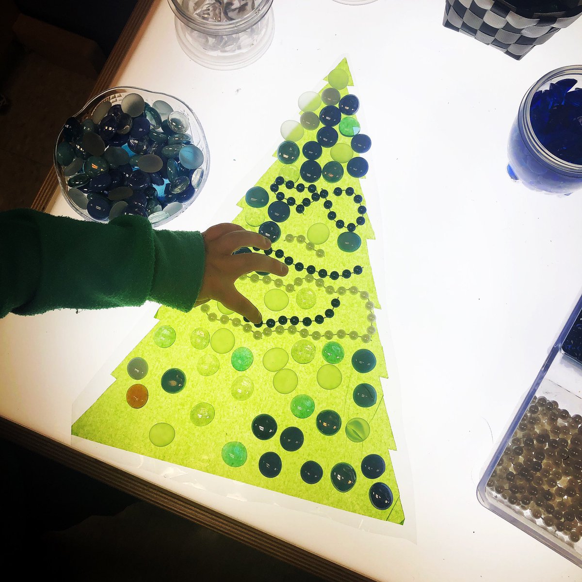 FDK_Lightning's tweet photo. Decorating a tree on the light table. I love the beautiful creations the students make, almost as much as I love the math that often happens. #kindergarten #mathhappens #looseparts #loosepartslighttable #lighttable https://t.co/x78diCKPr8