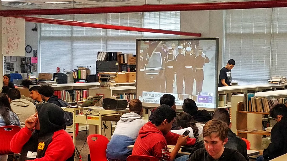 BaldLibrarian's tweet photo. Waltrip students paying last respects to President Bush in the library as they watch the ceremony at his train. #bush41 #Remembering41 #ramnation #waltriphighschool #baldlibrarian #librariesofinstagram #librariesofIG #ramnation #rambrary https://t.co/rg2T8UcyDi