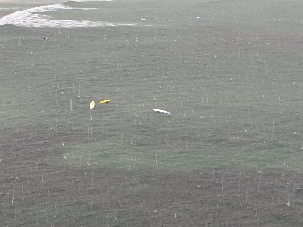 Surfers hiding under their boards to avoid the massive hailstones. #straya
