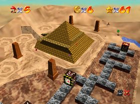 you can see in this screenshot that the pyramid is surrounded by four pillars, and there are black cubes outside. the pyramid has a star in the top, so there is a light in the capstone of this pyramid.