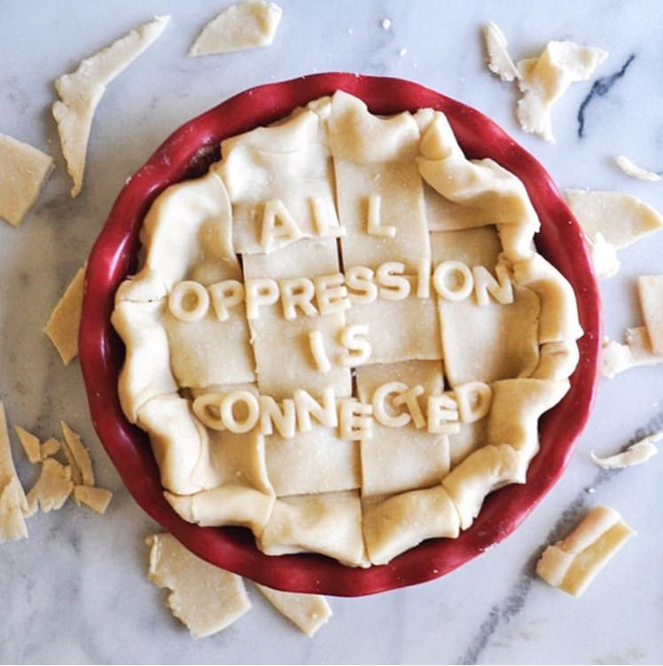 Photo of a pie in a dish that reads, "All oppression is connected."