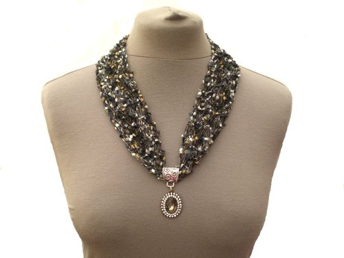 This unique necklace is hand knitted in delicate black and gold #ladderyarn and has a black #glasspendant surrounded by glittery #rhinestones. #knittednecklace #blackpendant #blacknecklace #etysfinds #etsyhandmade #etsysellers #etsyjewellery etsy.com/uk/listing/632…