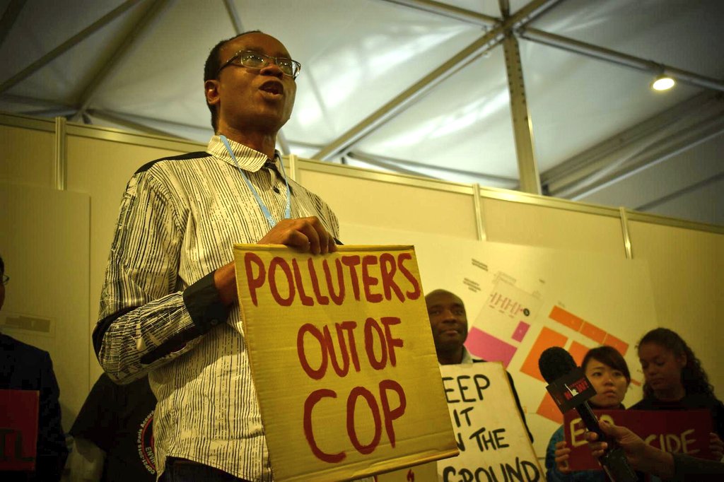 rjkennerley's tweet photo. "Oil companies populate the corridors of
#COP24. They are proud to claim their influence over the #ParisAgreement" @NnimmoB on @Shell and others polluting influence on the climate talks. It's time to kick Pollutors out of the COP
#COP24 #PollutersOut #PeopleIn https://t.co/z4nQummI41