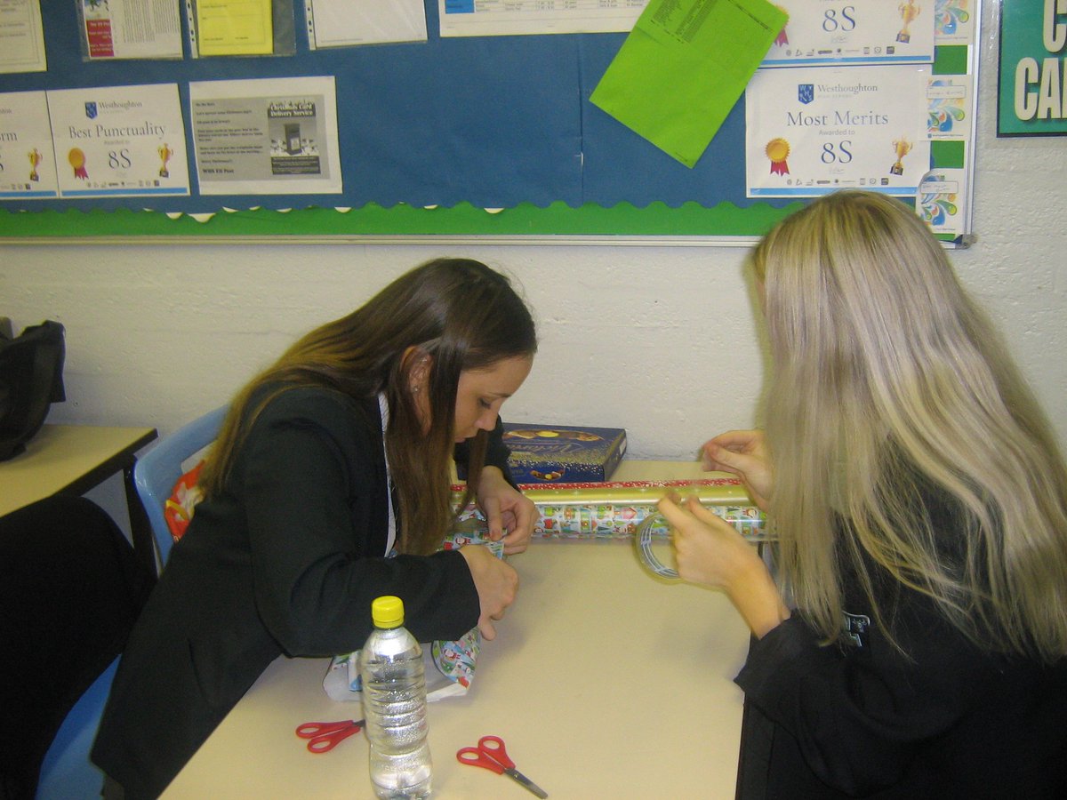 WesthoughtonHS's tweet photo. One more day to go, let's make a real difference to those who need our love and support over the festive season. Here are some images of our students helping wrap the gifts for 'adopt a grandparent' ready to go out into the community. https://t.co/1chNhPMpmX