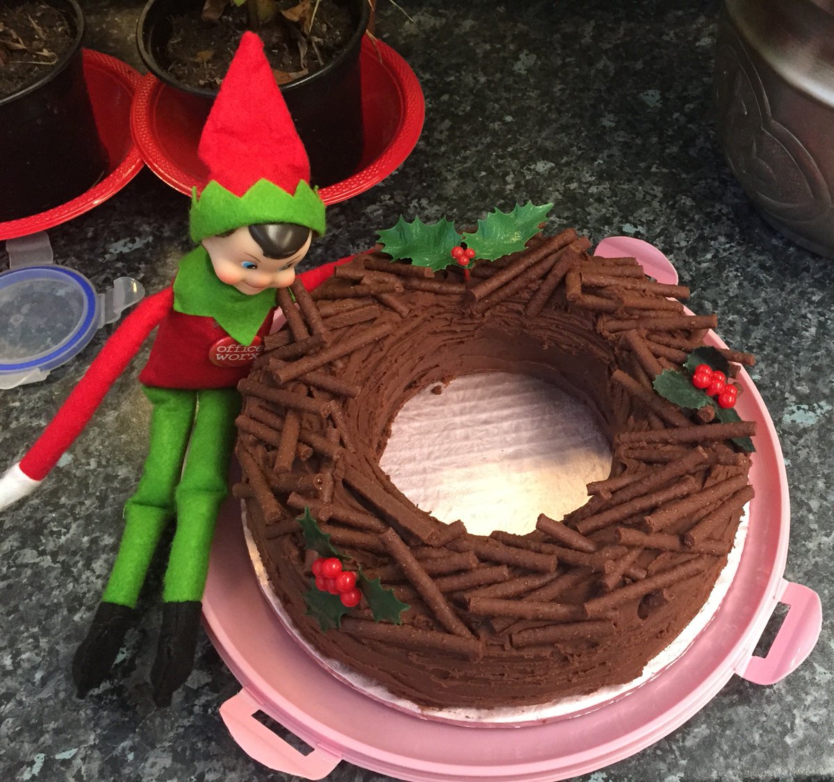 UniversalUniUK's tweet photo. We given this beautiful chocolate Christmas cake but naughty Ernie has eaten it all! Looking a bit green around the gills Ernie #OfficeworxElf #greedyelf https://t.co/Ae9i1hAw3N