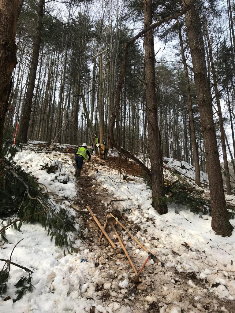 DukeEnergy's tweet photo. Our crews have not stopped working in the areas that Winter Storm #Diego hit hardest. In Waynesville, N.C., workers are climbing snow-covered hills to make repairs. In some cases, they are hand-digging poles and replacing them on uneven mountain terrain. https://t.co/vx6ASwZfm9