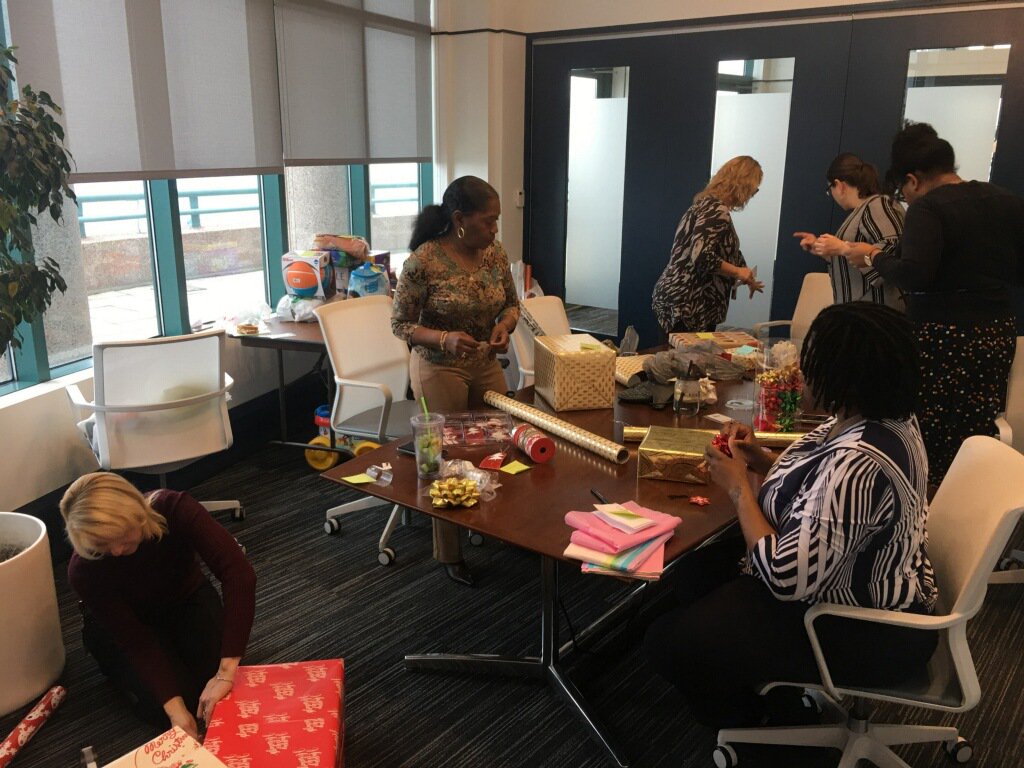 MarinersInn's tweet photo. Adopt-a-Family, presented this year by @artvan, is going to be so wonderful! Here's one of our board member's team at @millercanfield wrapping gifts in the office before the big event on Saturday! #seasonofgiving #recoveryisreal #marinersinn #millercanfield #grateful https://t.co/zjD0514Ff7
