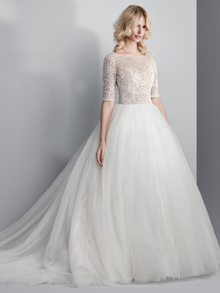 This Sottero&amp;Midgley ballgown is so incredible! It has a sheer bodice of Swarovski crystals and beading atop a voluminous tulle skirt. Complete with half-sleeves, an elegant illusion bateau over sweetheart neckline, and sexy open back. <a href="/maggiesottero/">Maggie Sottero Designs</a>