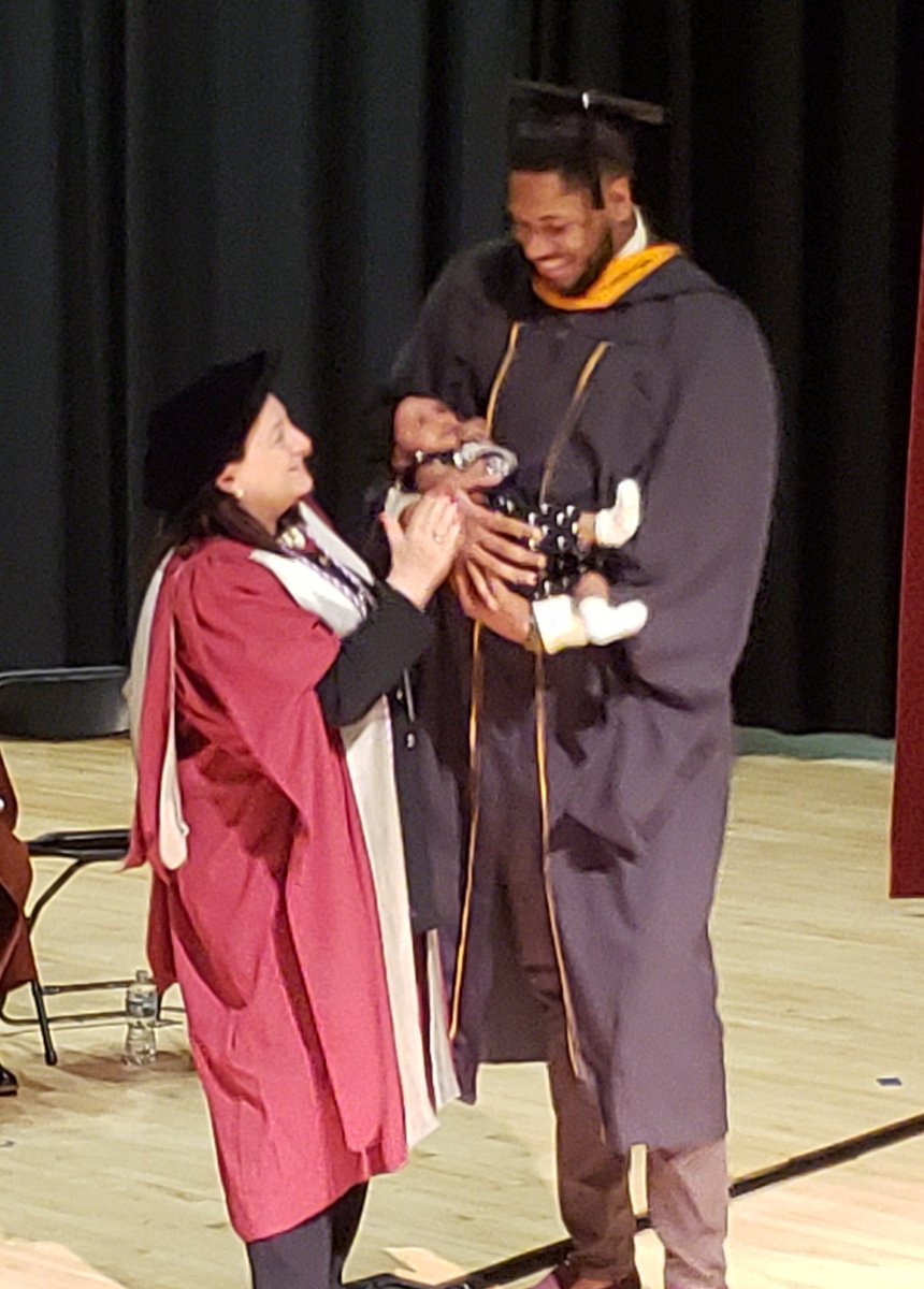 JHUNursing's tweet photo. #MSN grad Erique Gumbs accepts his degree with a special guest @nursingdean #Graduation https://t.co/rWxIXNc0S0