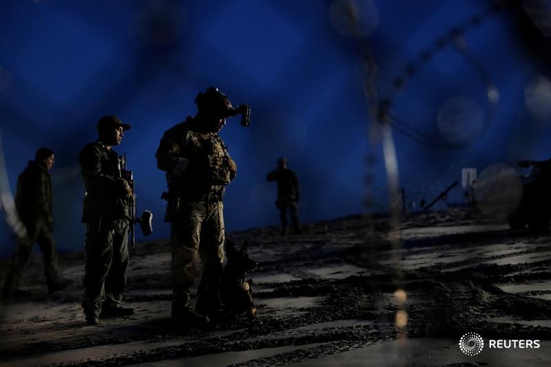 U.S. Customs and Border Protection officials stand guard next to the border wall after a group of migrants crossed illegally from Mexico to the U.S. More photos of the day: https://reut.rs/2LfhUfi 📷 @carlosrawlins