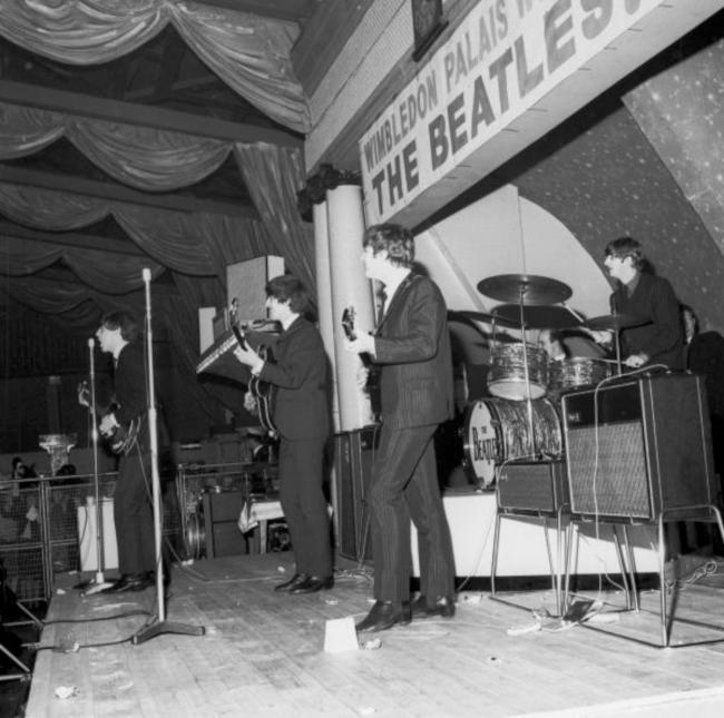 Musical_Soup's tweet photo. Today in 1963, The Beatles played a show for their Southern Area Fan Club at Wimbledon Palais, London. To prevent damage to the stage from fans the management of the Palais constructed a platform for The Beatles to perform on, surrounded by a steel cage. https://t.co/yOSZdY8uLp