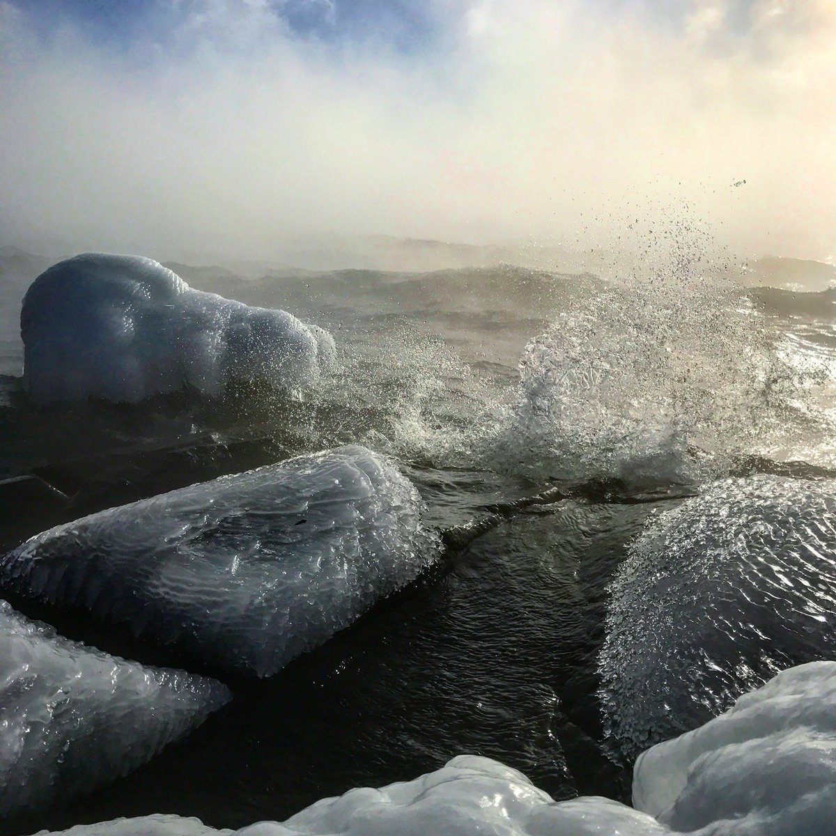 ParkPointMarina's tweet photo. We took this picture a couple years ago on a VERY cold day. It’s amazing how the freezing temperatures make #LakeSuperior look even cooler! Haha see what we did there? 😎 https://t.co/2sytlARr85