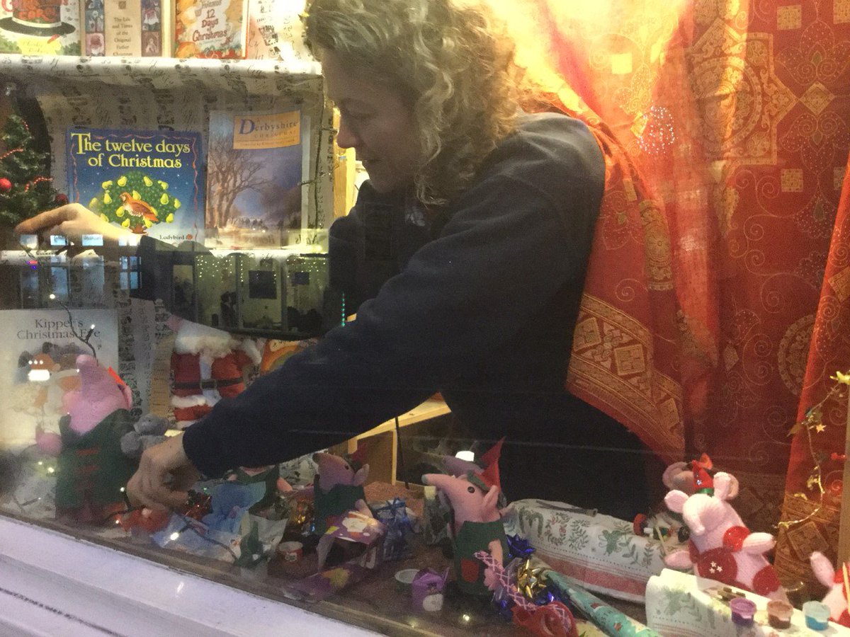 Here's our Bookbinder and Clanger costumier Janet, in the Christmas window installing our Clangers, who are helping in Santa's workshop as elves this Christmas.
