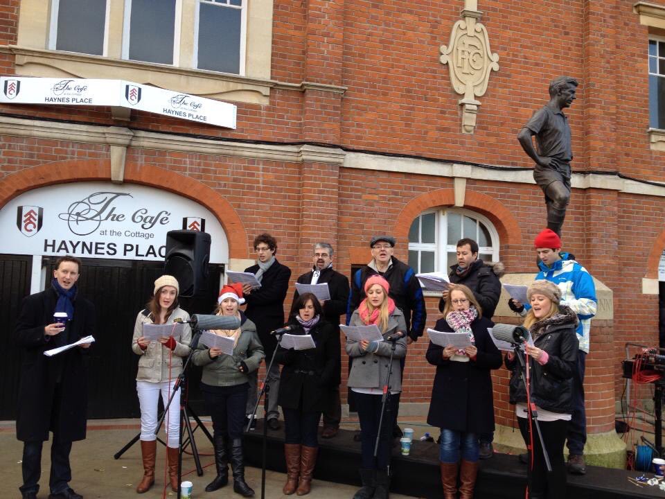 🎄Excited to be asked to sing Christmas Carols by <a href="/FulhamFC/">Fulham Football Club</a> before today’s  #FULWHU game. Fear the weather won’t be as nice today as in the photo 🤣 but we’ll be singing our hearts out anyway #COYW
